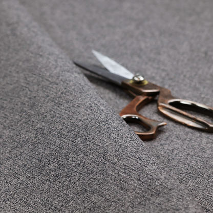 A fabric in storm grey. A balanced mid-to-dark grey weave featuring a complex interlacing of ash and soot.