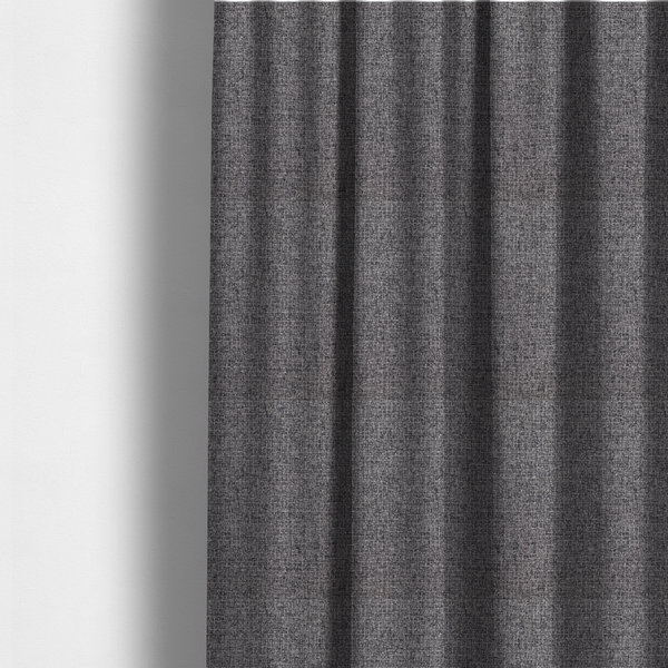 The fabric used to create these made-to-measure curtains is a fabric in storm grey. A balanced mid-to-dark grey weave featuring a complex interlacing of ash and soot.