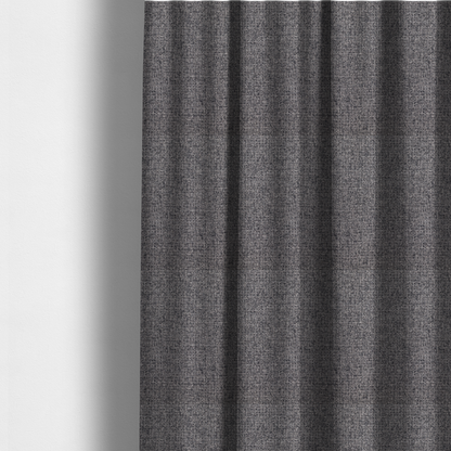 The fabric used to create these made-to-measure curtains is a fabric in storm grey. A balanced mid-to-dark grey weave featuring a complex interlacing of ash and soot.