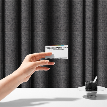 The fabric used to create these made-to-measure curtains is a fabric in storm grey. A balanced mid-to-dark grey weave featuring a complex interlacing of ash and soot.