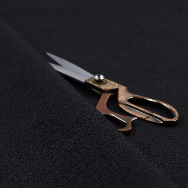 A fabric in midnight black. Dense, saturated weave of onyx and deep obsidian threads for a sleek matte finish.