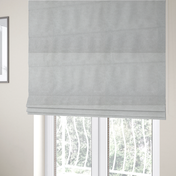 The fabric used to create these Roman blinds is a off-white with a dense, felt-like or fibrous texture. The material features a subtle, marbled appearance created by a blend of pale grey and off-white fibres, giving it a soft, matte finish similar to weathered wool or industrial felt.