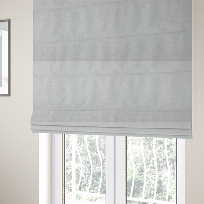 The fabric used to create these Roman blinds is a off-white with a dense, felt-like or fibrous texture. The material features a subtle, marbled appearance created by a blend of pale grey and off-white fibres, giving it a soft, matte finish similar to weathered wool or industrial felt.