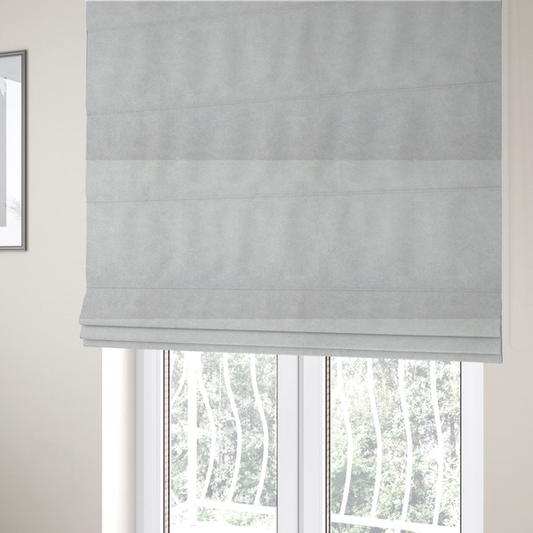 The fabric used to create these Roman blinds is a off-white with a dense, felt-like or fibrous texture. The material features a subtle, marbled appearance created by a blend of pale grey and off-white fibres, giving it a soft, matte finish similar to weathered wool or industrial felt.