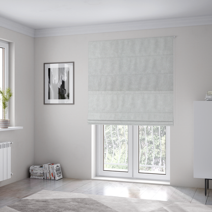 The fabric used to create these Roman blinds is a off-white with a dense, felt-like or fibrous texture. The material features a subtle, marbled appearance created by a blend of pale grey and off-white fibres, giving it a soft, matte finish similar to weathered wool or industrial felt.