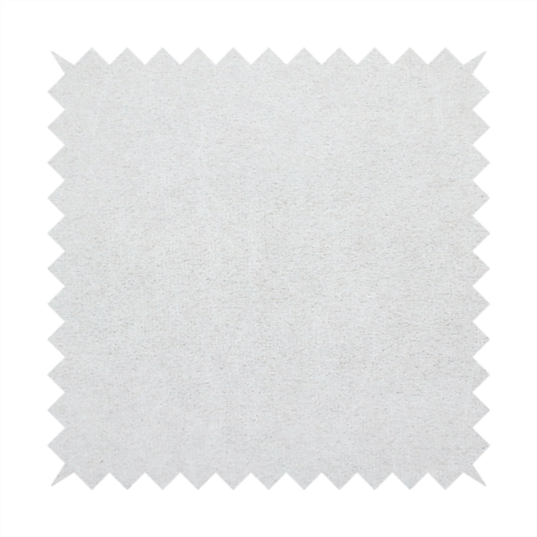 A creamy off-white fabric with a dense, velvety or short-pile texture. The surface is uniform and soft, featuring a fine, grainy appearance that suggests a plush material like micro-suede or high-end upholstery velvet.