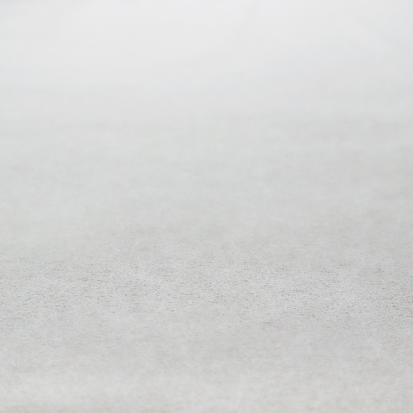 A creamy off-white fabric with a dense, velvety or short-pile texture. The surface is uniform and soft, featuring a fine, grainy appearance that suggests a plush material like micro-suede or high-end upholstery velvet.