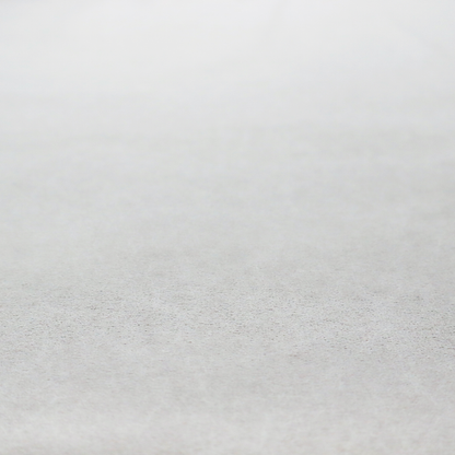 A creamy off-white fabric with a dense, velvety or short-pile texture. The surface is uniform and soft, featuring a fine, grainy appearance that suggests a plush material like micro-suede or high-end upholstery velvet.