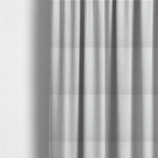 The fabric used to create these made-to-measure curtains is a creamy off-white fabric with a dense, velvety or short-pile texture. The surface is uniform and soft, featuring a fine, grainy appearance that suggests a plush material like micro-suede or high-end upholstery velvet.
