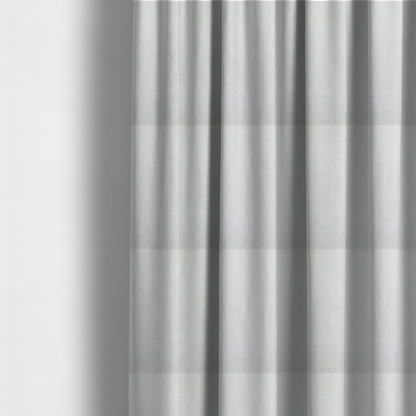 The fabric used to create these made-to-measure curtains is a creamy off-white fabric with a dense, velvety or short-pile texture. The surface is uniform and soft, featuring a fine, grainy appearance that suggests a plush material like micro-suede or high-end upholstery velvet.