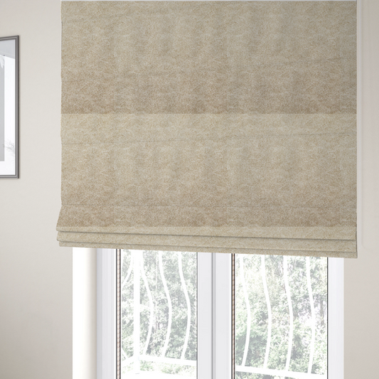 The fabric used to create these Roman blinds is a warm beige or tan fabric with a dense, felt-like or distressed texture. The material features a fine, mottled pattern where sandy brown fibres mix with ivory highlights. Subtle, irregular horizontal "veining" or crackle lines run across the surface, giving it an organic, lived-in look similar to soft suede or pressed wool.