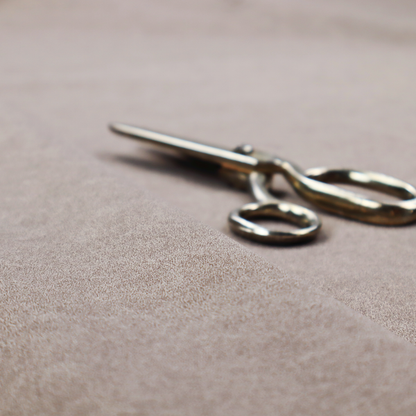 A taupe or mushroom-coloured fabric with a rich, distressed texture. The material features a fine, pebble-like grain combined with thin, irregular light-coloured "crackle" lines that mimic the look of aged leather or pressed felt. The colour is a sophisticated blend of dusty brown and grey tones with ivory highlights.