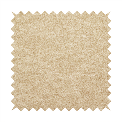 A golden-tan or sand-coloured fabric with a dense, weathered texture. The material has a soft, matte finish with a fine mottled pattern of light cream and warm brown fibres. Subtle, irregular horizontal "crackle" lines or faint creases run throughout the surface, giving it the weathered appearance of distressed suede or pressed wool.