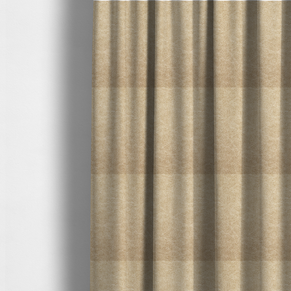The fabric used to create these made-to-measure curtains is a golden-tan or sand-coloured fabric with a dense, weathered texture. The material has a soft, matte finish with a fine mottled pattern of light cream and warm brown fibres. Subtle, irregular horizontal "crackle" lines or faint creases run throughout the surface, giving it the weathered appearance of distressed suede or pressed wool.