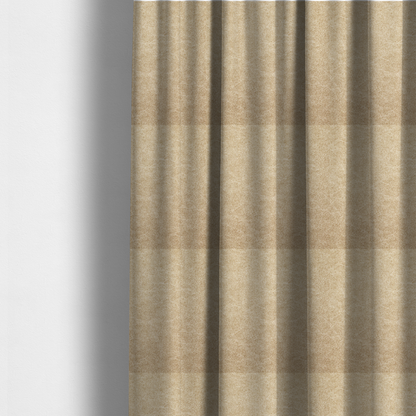 The fabric used to create these made-to-measure curtains is a golden-tan or sand-coloured fabric with a dense, weathered texture. The material has a soft, matte finish with a fine mottled pattern of light cream and warm brown fibres. Subtle, irregular horizontal "crackle" lines or faint creases run throughout the surface, giving it the weathered appearance of distressed suede or pressed wool.