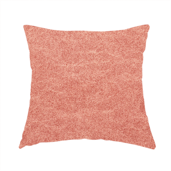The fabric used to create this handmade cushion is a terracotta or muted coral fabric with a rich, distressed texture. The material features a fine, stippled blend of reddish-clay tones and lighter peachy fibres. It is characterized by faint, irregular light-coloured "crackle" lines that give it the appearance of weathered suede, microfiber, or industrial felt.