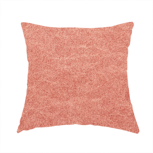 The fabric used to create this handmade cushion is a terracotta or muted coral fabric with a rich, distressed texture. The material features a fine, stippled blend of reddish-clay tones and lighter peachy fibres. It is characterized by faint, irregular light-coloured "crackle" lines that give it the appearance of weathered suede, microfiber, or industrial felt.