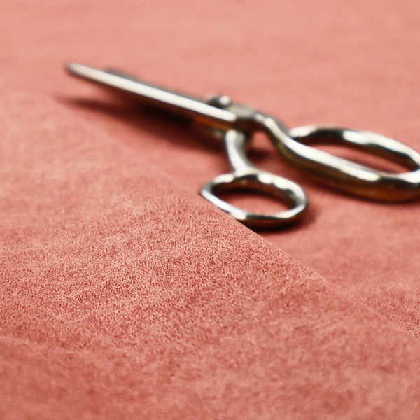 A terracotta or muted coral fabric with a rich, distressed texture. The material features a fine, stippled blend of reddish-clay tones and lighter peachy fibres. It is characterized by faint, irregular light-coloured "crackle" lines that give it the appearance of weathered suede, microfiber, or industrial felt.