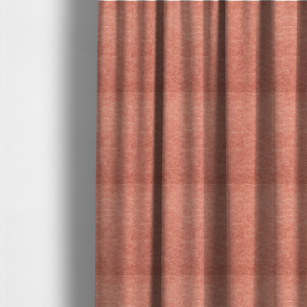 The fabric used to create these made-to-measure curtains is a terracotta or muted coral fabric with a rich, distressed texture. The material features a fine, stippled blend of reddish-clay tones and lighter peachy fibres. It is characterized by faint, irregular light-coloured "crackle" lines that give it the appearance of weathered suede, microfiber, or industrial felt.