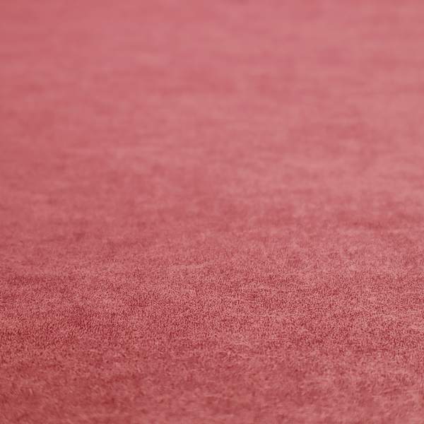 A deep rose or berry-red fabric with a rich, distressed felt-like texture. The surface features a fine, stippled pattern of muted red and soft pink fibres, creating a weathered effect. Delicate, irregular light-coloured "crackle" lines run throughout, giving it an organic, weathered look similar to suede or industrial-grade wool.