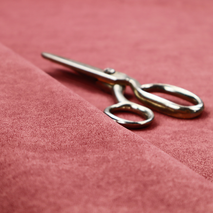A deep rose or berry-red fabric with a rich, distressed felt-like texture. The surface features a fine, stippled pattern of muted red and soft pink fibres, creating a weathered effect. Delicate, irregular light-coloured "crackle" lines run throughout, giving it an organic, weathered look similar to suede or industrial-grade wool.