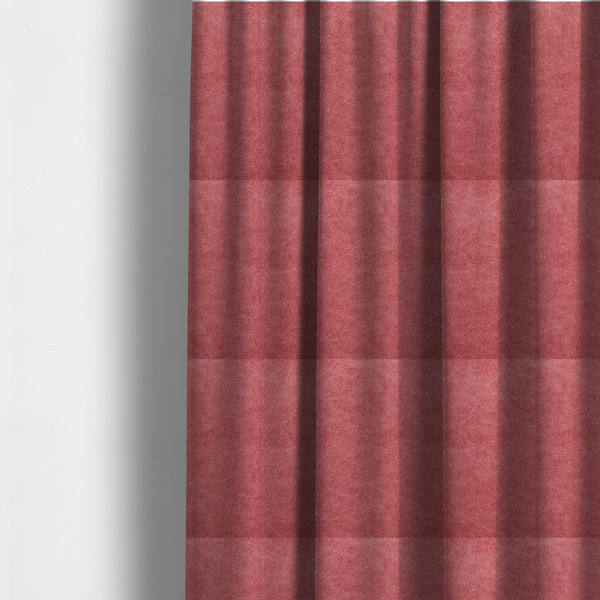 The fabric used to create these made-to-measure curtains is a deep rose or berry-red fabric with a rich, distressed felt-like texture. The surface features a fine, stippled pattern of muted red and soft pink fibres, creating a weathered effect. Delicate, irregular light-coloured "crackle" lines run throughout, giving it an organic, weathered look similar to suede or industrial-grade wool.