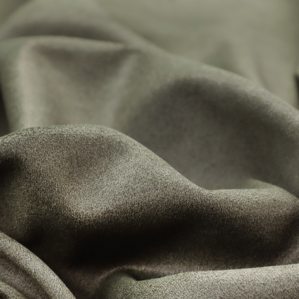 An olive-drab or sage-green fabric with a rich, distressed texture. The material features a dense, mottled pattern where dark earthy green fibres are interspersed with lighter, pale-green highlights. Like others in this series, it is characterized by faint, irregular light-coloured "crackle" lines that give it the appearance of weathered suede or industrial felt.
