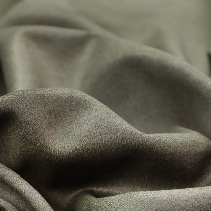 An olive-drab or sage-green fabric with a rich, distressed texture. The material features a dense, mottled pattern where dark earthy green fibres are interspersed with lighter, pale-green highlights. Like others in this series, it is characterized by faint, irregular light-coloured "crackle" lines that give it the appearance of weathered suede or industrial felt.