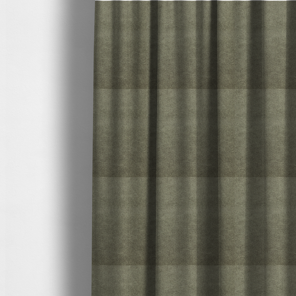 The fabric used to create these made-to-measure curtains is a olive-drab or sage-green fabric with a rich, distressed texture. The material features a dense, mottled pattern where dark earthy green fibres are interspersed with lighter, pale-green highlights. Like others in this series, it is characterized by faint, irregular light-coloured "crackle" lines that give it the appearance of weathered suede or industrial felt.