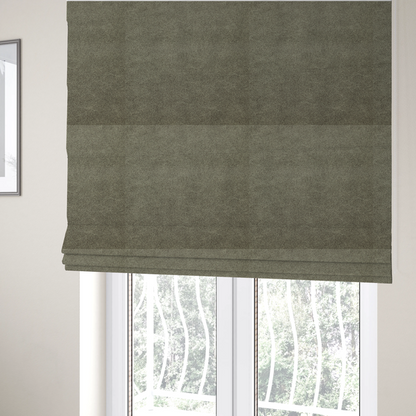 The fabric used to create these Roman blinds is a olive-drab or sage-green fabric with a rich, distressed texture. The material features a dense, mottled pattern where dark earthy green fibres are interspersed with lighter, pale-green highlights. Like others in this series, it is characterized by faint, irregular light-coloured "crackle" lines that give it the appearance of weathered suede or industrial felt.