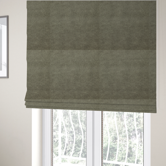 The fabric used to create these Roman blinds is a olive-drab or sage-green fabric with a rich, distressed texture. The material features a dense, mottled pattern where dark earthy green fibres are interspersed with lighter, pale-green highlights. Like others in this series, it is characterized by faint, irregular light-coloured "crackle" lines that give it the appearance of weathered suede or industrial felt.