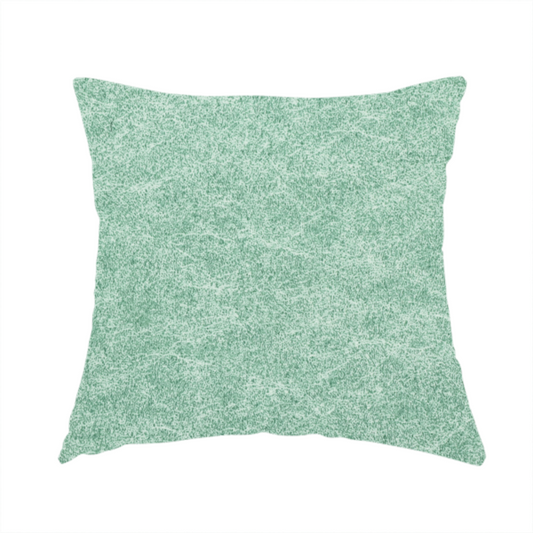 The fabric used to create this handmade cushion is a seafoam or sage green fabric with a rich, distressed felt-like texture. The material features a vibrant yet soft mottled pattern of mint green and pale cream fibres. It is characterized by the signature irregular, light-coloured "crackle" lines found in this collection, giving it the weathered appearance of premium suede or industrial wool.