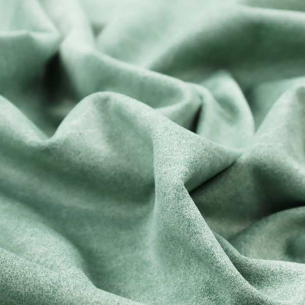 A seafoam or sage green fabric with a rich, distressed felt-like texture. The material features a vibrant yet soft mottled pattern of mint green and pale cream fibres. It is characterized by the signature irregular, light-coloured "crackle" lines found in this collection, giving it the weathered appearance of premium suede or industrial wool.