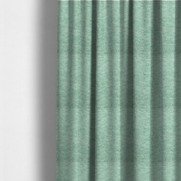 The fabric used to create these made-to-measure curtains is a seafoam or sage green fabric with a rich, distressed felt-like texture. The material features a vibrant yet soft mottled pattern of mint green and pale cream fibres. It is characterized by the signature irregular, light-coloured "crackle" lines found in this collection, giving it the weathered appearance of premium suede or industrial wool.