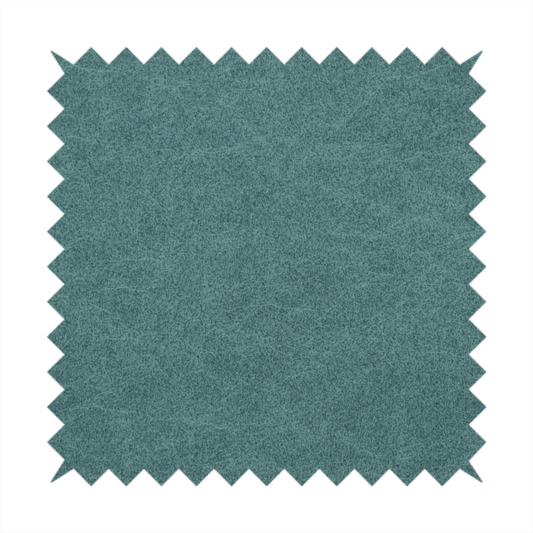 A teal or dark seafoam green fabric with a dense, distressed felt-like texture. The surface features an intricate mottled pattern of deep blue-green fibres mixed with lighter cyan highlights. It contains the signature irregular, light-coloured "crackle" veins seen throughout this collection, giving it the weathered appearance of premium distressed suede or heavy-duty wool.