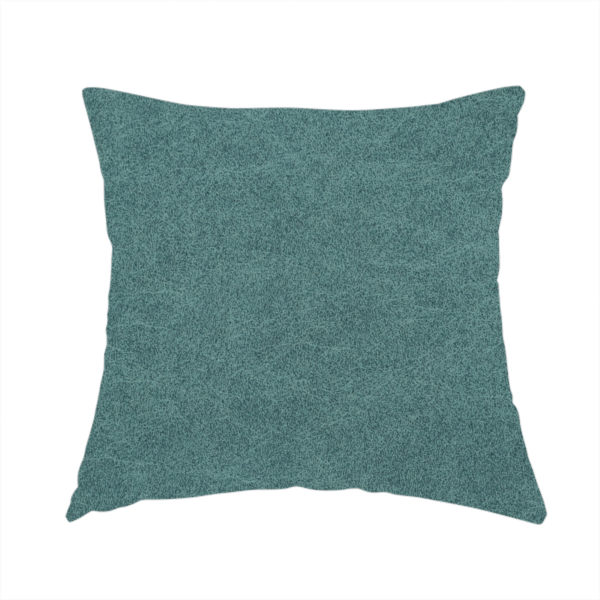 The fabric used to create these handmade cushions is a teal or dark seafoam green fabric with a dense, distressed felt-like texture. The surface features an intricate mottled pattern of deep blue-green fibres mixed with lighter cyan highlights. It contains the signature irregular, light-coloured "crackle" veins seen throughout this collection, giving it the weathered appearance of premium distressed suede or heavy-duty wool.