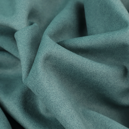 A teal or dark seafoam green fabric with a dense, distressed felt-like texture. The surface features an intricate mottled pattern of deep blue-green fibres mixed with lighter cyan highlights. It contains the signature irregular, light-coloured "crackle" veins seen throughout this collection, giving it the weathered appearance of premium distressed suede or heavy-duty wool.