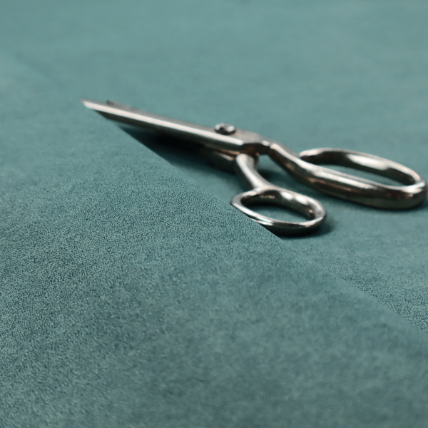 A teal or dark seafoam green fabric with a dense, distressed felt-like texture. The surface features an intricate mottled pattern of deep blue-green fibres mixed with lighter cyan highlights. It contains the signature irregular, light-coloured "crackle" veins seen throughout this collection, giving it the weathered appearance of premium distressed suede or heavy-duty wool.