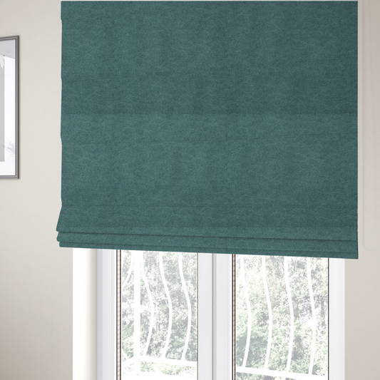 The fabric used to create these Roman blinds is a teal or dark seafoam green fabric with a dense, distressed felt-like texture. The surface features an intricate mottled pattern of deep blue-green fibres mixed with lighter cyan highlights. It contains the signature irregular, light-coloured "crackle" veins seen throughout this collection, giving it the weathered appearance of premium distressed suede or heavy-duty wool.