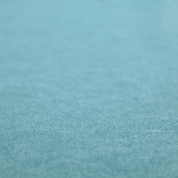 A bright aqua or turquoise fabric with a dense, distressed felt-like texture. The surface features a vibrant mottled pattern of cyan and pale blue fibres, creating a weathered effect. It is characterized by irregular, light-coloured "crackle" lines that give it the weathered appearance of premium suede or industrial wool.