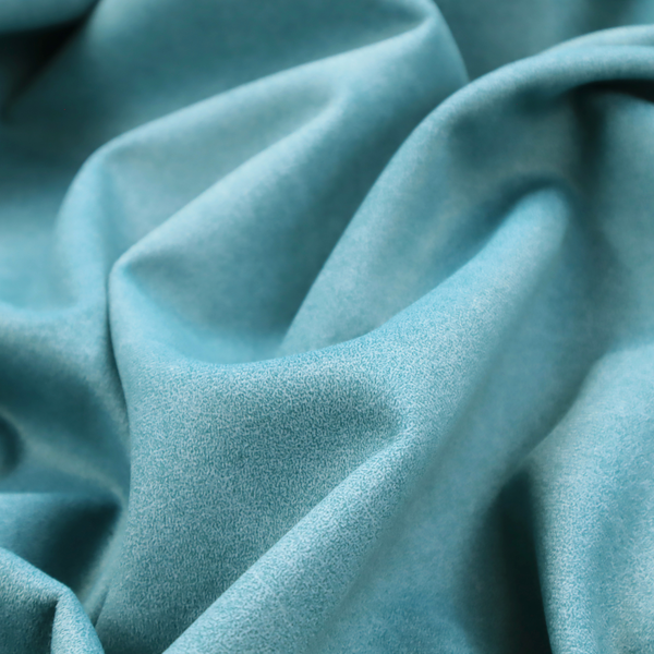 A bright aqua or turquoise fabric with a dense, distressed felt-like texture. The surface features a vibrant mottled pattern of cyan and pale blue fibres, creating a weathered effect. It is characterized by irregular, light-coloured "crackle" lines that give it the weathered appearance of premium suede or industrial wool.