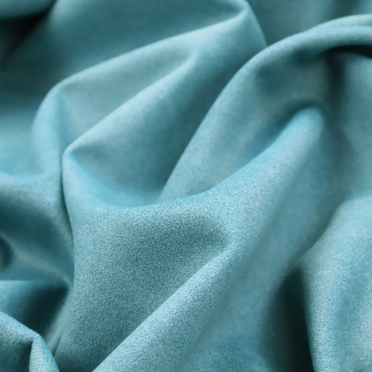A bright aqua or turquoise fabric with a dense, distressed felt-like texture. The surface features a vibrant mottled pattern of cyan and pale blue fibres, creating a weathered effect. It is characterized by irregular, light-coloured "crackle" lines that give it the weathered appearance of premium suede or industrial wool.
