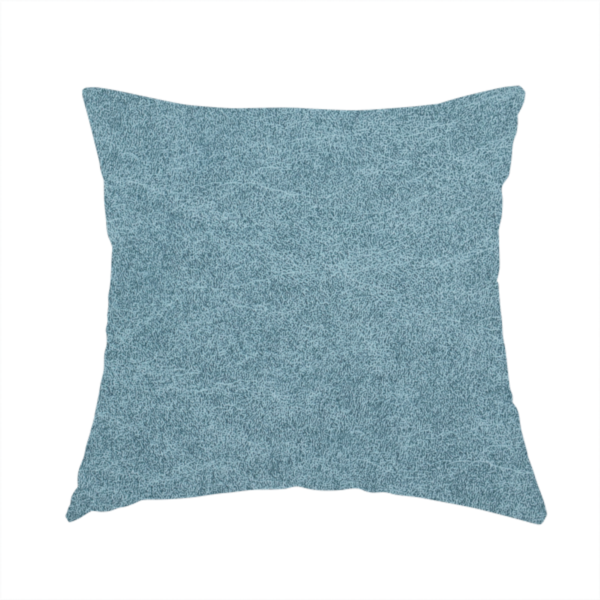 The fabric used to create this handmade cushion is a dusty blue or slate blue fabric with a dense, distressed felt-like texture. The material features a sophisticated mottled pattern of medium blue and muted grey fibres. It contains the signature irregular, light-coloured "crackle" veins characteristic of this collection, giving it the weathered appearance of premium distressed suede or industrial wool.