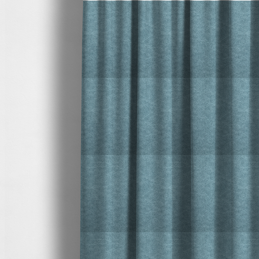 The fabric used to create these made-to-measure curtains is a dusty blue or slate blue fabric with a dense, distressed felt-like texture. The material features a sophisticated mottled pattern of medium blue and muted grey fibres. It contains the signature irregular, light-coloured "crackle" veins characteristic of this collection, giving it the weathered appearance of premium distressed suede or industrial wool.
