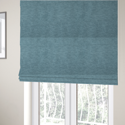 The fabric used to create these Roman blinds is a  dusty blue or slate blue fabric with a dense, distressed felt-like texture. The material features a sophisticated mottled pattern of medium blue and muted grey fibres. It contains the signature irregular, light-coloured "crackle" veins characteristic of this collection, giving it the weathered appearance of premium distressed suede or industrial wool.