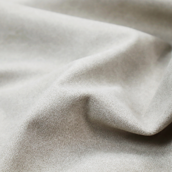 A pale greige or parchment-coloured fabric with a dense, distressed felt-like texture. The surface features a subtle mottled pattern of light cream and soft grey fibres, creating a clean, weathered look. Like the others in this collection, it includes irregular, light-coloured "crackle" lines that give it the weathered appearance of distressed suede or pressed wool.