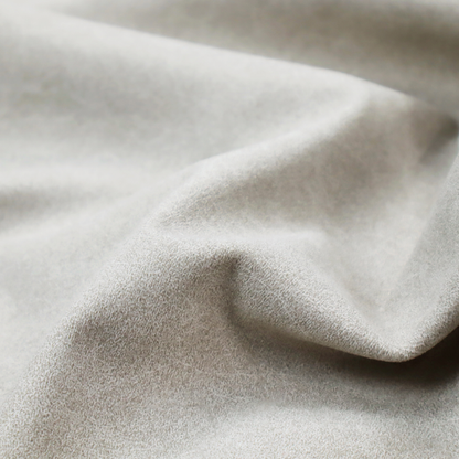 A pale greige or parchment-coloured fabric with a dense, distressed felt-like texture. The surface features a subtle mottled pattern of light cream and soft grey fibres, creating a clean, weathered look. Like the others in this collection, it includes irregular, light-coloured "crackle" lines that give it the weathered appearance of distressed suede or pressed wool.