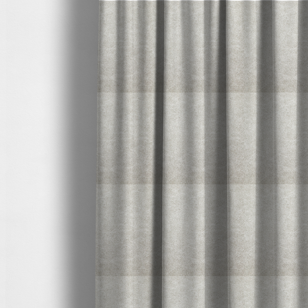 The fabric used to create these made-to-measure curtains is a pale greige or parchment-coloured fabric with a dense, distressed felt-like texture. The surface features a subtle mottled pattern of light cream and soft grey fibres, creating a clean, weathered look. Like the others in this collection, it includes irregular, light-coloured "crackle" lines that give it the weathered appearance of distressed suede or pressed wool.