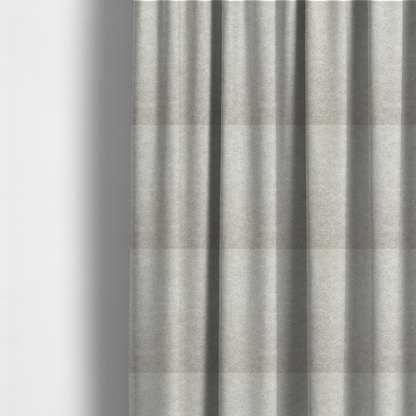 The fabric used to create these made-to-measure curtains is a pale greige or parchment-coloured fabric with a dense, distressed felt-like texture. The surface features a subtle mottled pattern of light cream and soft grey fibres, creating a clean, weathered look. Like the others in this collection, it includes irregular, light-coloured "crackle" lines that give it the weathered appearance of distressed suede or pressed wool.