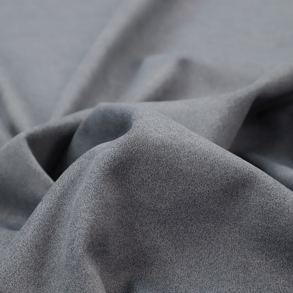 A charcoal or slate grey fabric with a rich, distressed felt-like texture. The surface features an intricate, stippled pattern of deep grey fibres mixed with lighter silver highlights. It is characterized by organic, vein-like distressing and light-coloured crackle lines, mimicking the look of weathered leather or heavy-duty industrial felt.